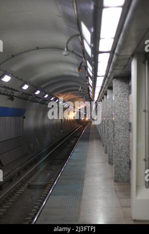 Worn and weathered old Chicago CTA public train station subway tunnel deep underground. Stock Photo