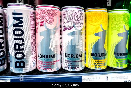 Samara, Russia - April 07, 2022: Borjomi canned beverages ready for sale on the shelf in a superstore. Various bottled beverages and non alcoholic dri Stock Photo