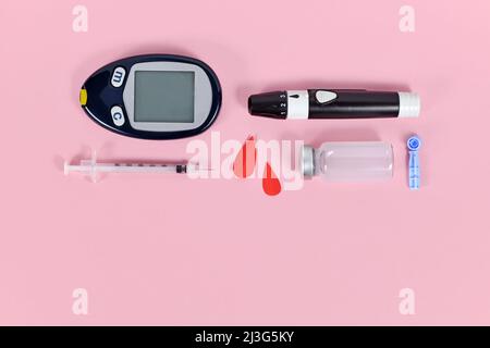 Diabetes treatment equipment with blood glucose sugar meter, lancets, insulin vial and syringes Stock Photo