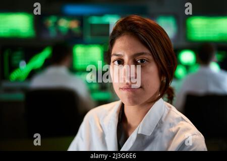 Female Medical doctor looking at the camera. Research woman Scientist in a Biological Applied Science Research Laboratory. Lab Engineers in White Stock Photo