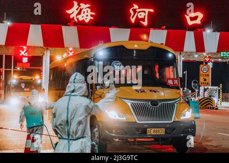 (220408) -- CHANGCHUN, April 8, 2022 (Xinhua) -- Staff members disinfect school buses transporting supportive team members from Changchun in Meihekou City, northeast China's Jilin Province, April 3, 2022. Some 5,000 supportive staff from Meihekou City who are aiding Changchun, one of the hardest-hit cities in China amid the latest virus resurgence, commute between the two cities every day in order to lessen boarding and lodging burdens on Changchun. The supportive team members, including medics, government officials and police officers, start off early morning and get back in late night, both Stock Photo