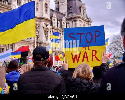 Demonstration gathering against the invasion of Ukraine by Russia, in memory of the victims of the genocide of Boutcha in Ukraine, on the square of the Town Hall. Portrait of a young woman demonstrator holding a sign with the message bucha, with the colors of the Ukrainian flag and a broken heart, during the demonstration. Paris, France on April 6, 2022. Photo by Karim Ait Adjedjou/Avenir Pictures/ABACAPRESS.COM Stock Photo