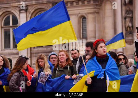 Demonstration gathering against the invasion of Ukraine by Russia, in memory of the victims of the genocide of Boutcha in Ukraine, on the square of the Town Hall. Portrait of a young woman demonstrator holding a sign with the message bucha, with the colors of the Ukrainian flag and a broken heart, during the demonstration. Paris, France on April 6, 2022. Photo by Karim Ait Adjedjou/Avenir Pictures/ABACAPRESS.COM Stock Photo