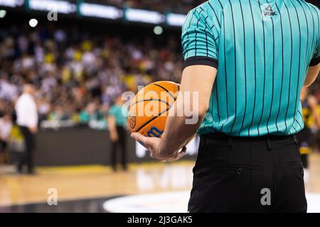 referee holding Champions League basketball during game Stock Photo