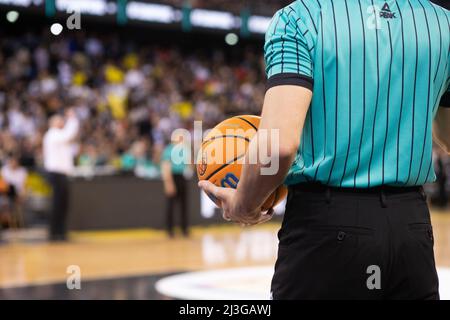 referee holding Champions League basketball during game Stock Photo