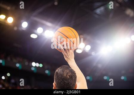 referee holding Champions League basketball during game Stock Photo