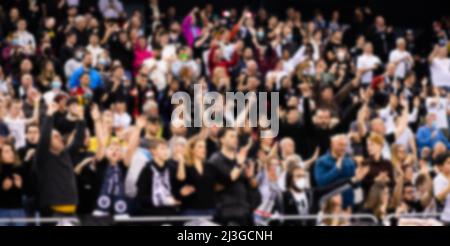 blurred background of supporters at sports event crowd of people in a basketball court Stock Photo