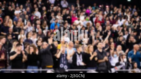 blurred background of supporters at sports event crowd of people in a basketball court Stock Photo