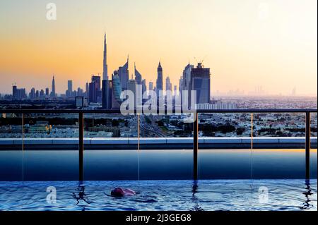 Dubai. UAE. View of the city at sunset from a rooftop pool Stock Photo