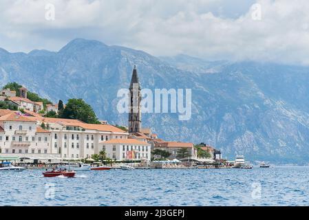 PERAST, MONTENEGRO - JULY 20, 2021: Coastal town of Perast with mountains in the background Stock Photo
