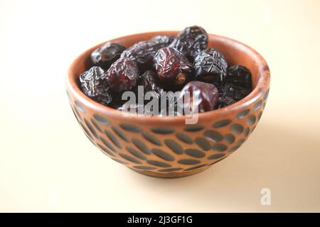 close up of fresh date fruit in a bowl on table  Stock Photo