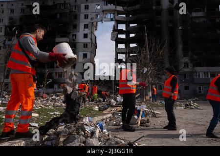 Volunteers clean the streets of debris near a bombed building in Borodyanka, Ukraine on April 7, 2022. Russian military forces entered Ukraine territory on Feb. 24, 2022. (Photo by Daniel Brown/Sipa USA) Stock Photo