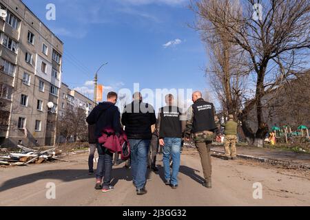 War crimes prosecutors walk down the streets of Borodyanka, Ukraine on April 7, 2022. Russian military forces entered Ukraine territory on Feb. 24, 2022. (Photo by Daniel Brown/Sipa USA) Stock Photo