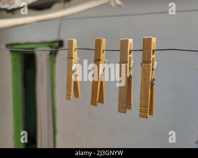 Clothes pins hanging on a wire Stock Photo