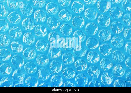 The texture of the packaging air-bubble film on a blue background in full screen Stock Photo