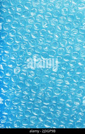 The texture of the packaging air-bubble film on a blue background in full screen Stock Photo