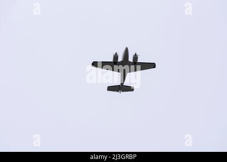 Beech 58 Baron twin engine plane N7223Y flying overhead London Southend Airport, Essex, UK, in heavy overcast sky. Transiting airspace below cloud Stock Photo