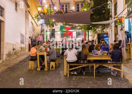 Portugal, Lisbon, Alfama district, people dining in the street during the Festas dos Santos Populares, (Festivals of Popular Saints) Stock Photo