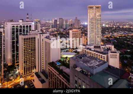 Philippines, Metro Manila, Makati District, elevated view of skyscrapers and Mandarin Oriental Hotel at dusk