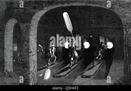 Manufacture of Glass for &quot;The Crystal Palace&quot;, at Messrs. Chance's Works, Spon-Lane, near Birmingham, 1850. Workers making an '...immense quantity of plate glass required for the &quot;Crystal&quot; Palace...[it is] blown into a spherical form [and] swung in the manner represented, above the head and below the feet of the workman, until it assumes the form of a cylinder. The workman stands upon a stage opposite the month of the furnace, with a pit or well beneath his feet...He swings and balances the molten metal - firmly affixed to a knob of glass at the end of a long iron bar, or b Stock Photo