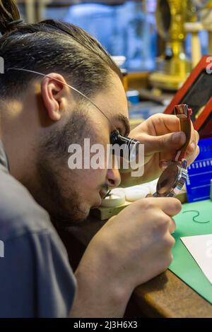 France, Indre et Loire, Loire valley listed as World Heritage by UNESCO, Loches, Vassort-Jouvert watchmaking workshop, before being a watchmaking workshop, a drugstore was founded there in 1730, the master watchmaker Gilles Vassort in his repair workshop and his two apprentices Stock Photo