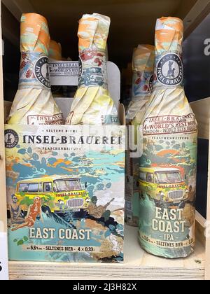 Viersen, Germany - April 5. 2022: Closeup of collection craft beer bottles wrapped in artful vintage style paper from german local Insel-Brauerei in s Stock Photo