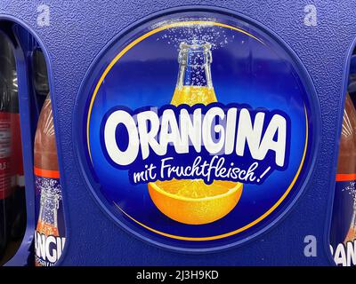 Viersen, Germany - April 5. 2022: Closeup of blue crate box with logo lettering of orangina lemonade in  german supermarket (focus on center) Stock Photo