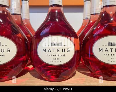 Viersen, Germany - April 5. 2022: Closeup of bottles portuguese mateus rose wine in shelf of german supermarket Stock Photo