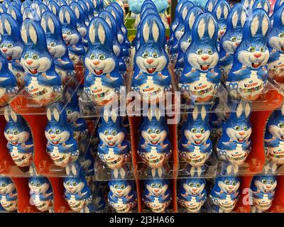 Viersen, Germany - April 5. 2022: Closeup of countless blue kinder chocolate easter bunnies stacked in rows in german supermarket Stock Photo