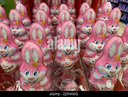 Viersen, Germany - April 5. 2022: Closeup of many pink kinder chocolate easter bunnies in  shelf of german supermarket Stock Photo