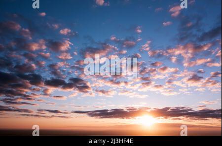 Natural abstract background. Morning dawn sky, clouds illuminated by the scorching morning sun. Stock Photo