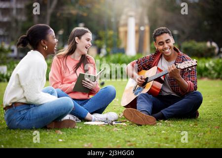 You can call us best friends. Shot of three students sitting together on campus. Stock Photo