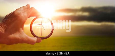 View through a glass with focus on a wind turbine Stock Photo