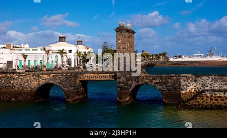 Canary Islands, Lanzarote, volcanic island, capital Arrecife, Puente de las Bolas, behind it town hall, sea green, sky blue with white clouds Stock Photo