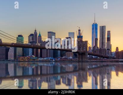 Dumbo, New York City, NY, USA, Iconic shot of the Brooklyn Bridge over East River and the skyline of manhattan with one world trade center Stock Photo