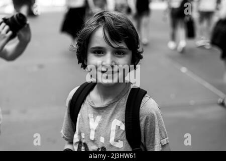 5 Avenue & West 54 Street, New York City, NY, USA, 12 years old caucasian teenager boy - with brown hair and in summer outfit on the streets of NYC Stock Photo