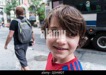 28 Street, New York City, NY, USA, 12 years old caucasian teenager boy - with brown hair and in summer outfit somewhere in NYC Stock Photo