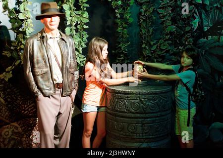 Theater District, New York City, NY, USA, 14 years old caucasian teenager girl and 12 years old caucasian teenager boy - both with brown hair and summer styling next to Indiana Jones at Madame Tussauds Stock Photo