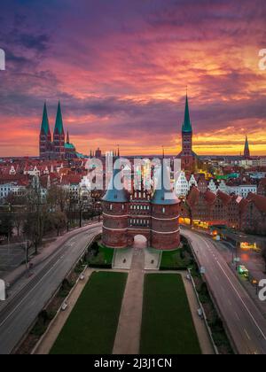 Sunrise at the Holsten Gate (Holstentor) in Lubeck, Germany Stock Photo