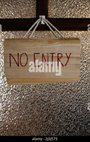 NO ENTRY sign in front of an old glass door in Sa Cabaneta on the island of Mallorca in Spain Stock Photo
