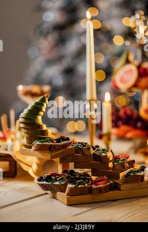 Blurred image of different types of bruschetta with cheese and fruits in a cardboard box. Takeaway food concept.Catering Service Photography. Stock Photo
