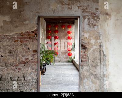 The blur concrete entrance as foregound, Chinese lantern hanging on the wall. Stock Photo