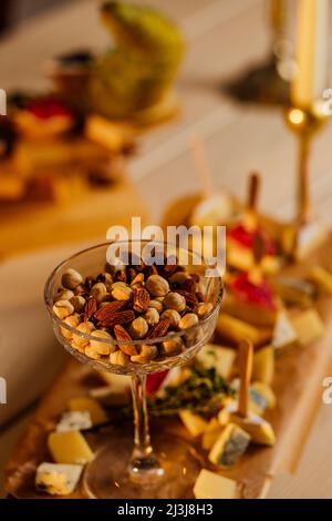 Nuts mix in a wooden plate. Catering Service Photography. Stock Photo