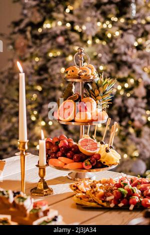 Beautifully decorated catering banquet table with different food snacks and appetizers on corporate christmas birthday party event or wedding celebrat Stock Photo