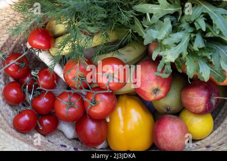 View from above into a shopping basket filled with fruits and vegetables from the local weekly market in Germany Stock Photo