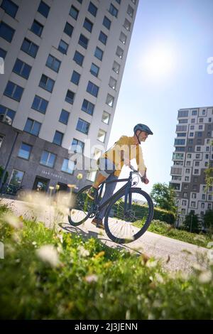 middle-aged man on bicycle, urban, Munich, Germany Stock Photo