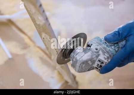 Worker hands cutting the floor ceramic tile by circular saw Stock Photo