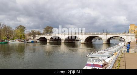 Kingston upon Thames, London, UK, April 5th 2022: Private and small hire boats moored on the banks of the River Thames by the elegant Kingston Bridge. Stock Photo