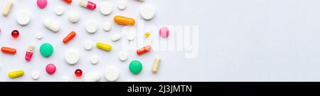 Many different pills and space for text on colorful background, top view. Different pills Stock Photo