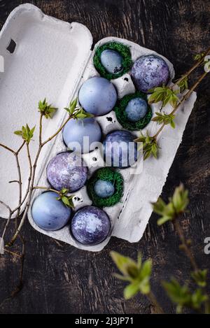 Festive Easter eggs in purple and blue color Stock Photo